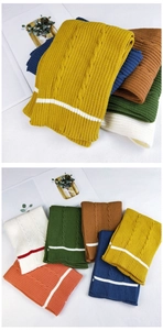Detailed cable knit pattern on thick striped winter scarves in various autumn colors