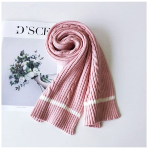 Close-up of pink knit scarf featuring thick cable knit patterns and white stripes
