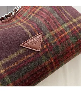 Detail of checkered wool handbag showing triangle leather patch and fashion bags logo