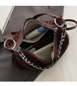 Interior view of the plaid shoulder bag showing large capacity for phone and wallet