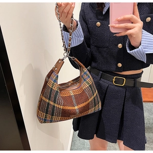 Classic plaid woolen handbag with leather handle and metal chain shown on model