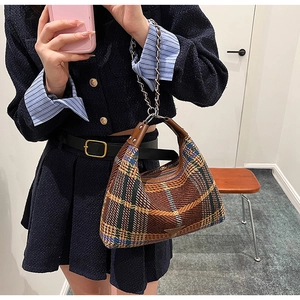 Close-up of vintage plaid hobo bag featuring wool fabric and metal chain strap