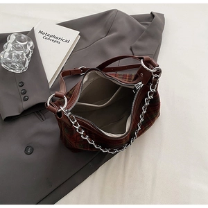 Detailed top view of vintage plaid wool handbag with brown leather strap and silver chain