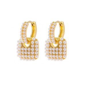 Elegant gold earrings featuring micro pearl heart charms and chic metal hoops