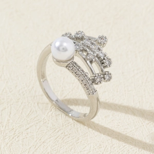 Macro shot of elegant pearl ring with cubic zirconia micro-pave and silver band