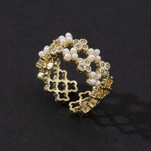 Elegant gold open ring featuring pearl accents and zircon flower pattern on black background
