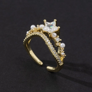 Detail of adjustable gold ring featuring a star-shaped zircon and elegant pearls