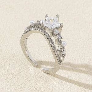 Detail of adjustable star zircon ring with delicate pearls and layered silver band