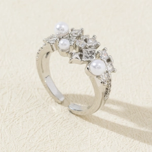 Macro shot of silver adjustable pearl ring with pavé-set cubic zirconia details
