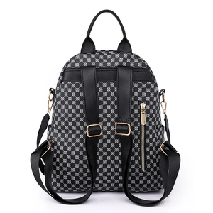 Women's chic black and white geometric backpack with gold hardware and anti-theft back pocket