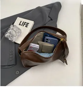 Deep brown saddle bag interior showcasing large capacity and smooth metal zipper