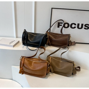 Detailed display of four leather saddle bags with varied woven and thin shoulder straps