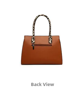 Detailed back view of brown lychee-grain faux leather handbag with leopard print handle