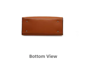Detail view of the brown leather bag base featuring four silver metal protective studs