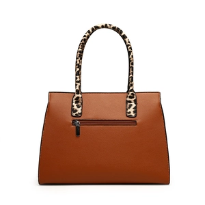 Brown leather tote bag with leopard print handles and a back zipper pocket on white background