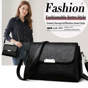 Sac à bandoulière noir en cuir texturé avec fermoir en métal argenté pour femmes