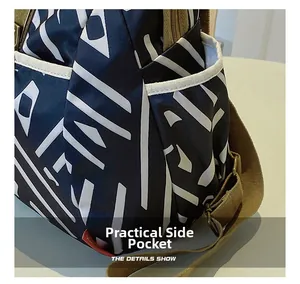 Detail showing the practical side pocket on a geometric pattern oxford fabric backpack