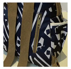 Close-up of durable smooth metal zipper and side pocket on printed oxford backpack