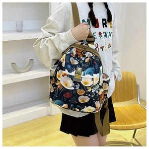 Detailed close-up of floral printed oxford fabric backpack with side pocket and tan straps