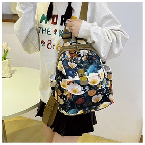 Detail of floral printed oxford backpack with adjustable green straps and side pockets
