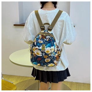 Detail of floral print oxford backpack featuring golden buckle and khaki straps