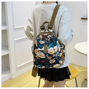 Detailed view of floral Oxford backpack with adjustable straps and metal buckle pocket