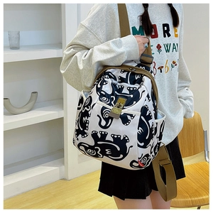 Side view of printed oxford fabric backpack with animal patterns and brown wide strap