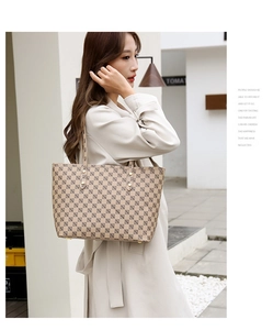 Detail view of large capacity checkerboard tote bag with letter print on a street model