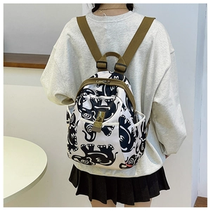 Close-up of elephant print oxford backpack with metal buckle and adjustable straps