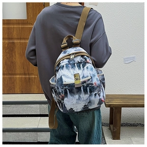 Detail of oxford fabric backpack with ink landscape print and khaki webbing straps