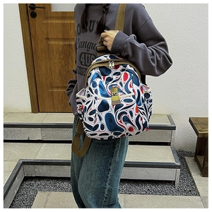 Fashionable oxford backpack with red and blue swirls print shown on female model