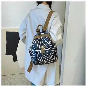 Detailed back view of printed Oxford fabric backpack with geometric stripes and brown straps