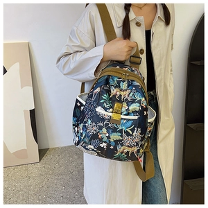 Detail of floral leopard print oxford backpack with gold zippers worn by model