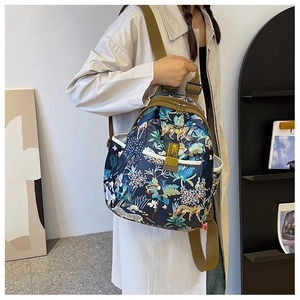 Detail of multi-functional jungle print oxford backpack with leopard and toucan patterns