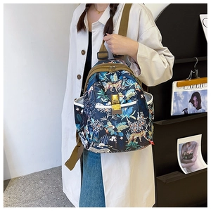 Detail of tropical jungle print backpack showing leopard patterns and side pocket