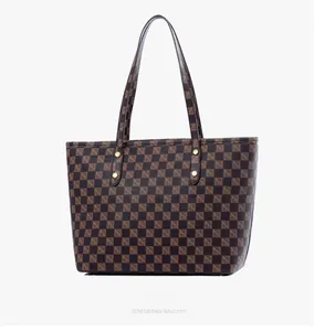 Macro view of checkered pattern tote bag with double straps and golden rivet accents