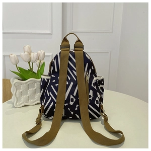 Detail of printed oxford fabric backpack with adjustable straps and floral decoration