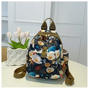 Close-up of floral print oxford backpack with olive green straps and metal buckle