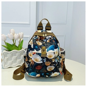 Detail showing floral print oxford fabric and gold buckle on the stylish backpack