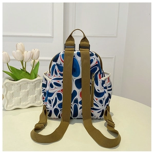 Detail view of printed oxford backpack with anti-theft zipper pocket and green straps