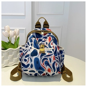 Detail of oxford backpack with blue fluid patterns and olive green adjustable straps