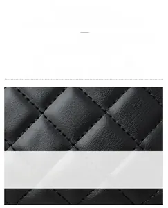 Close-up of black oil wax leather with classic diamond quilted stitching on bag