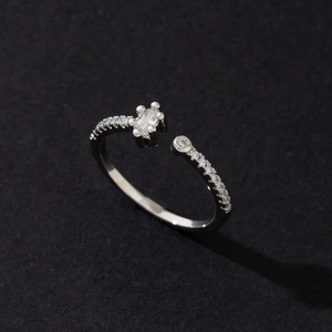 Nahaufnahme eines silbernen offenen Rings mit rechteckigem Zirkonia und Pavé-Fassung