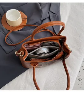 Interior view showing large capacity and multi-compartment design of the brown tote bag