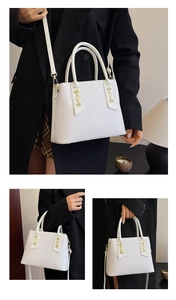 Detail of white crocodile texture handbag with gold chain and cylindrical handle