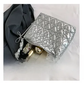 Silver heart-quilted tote bag showing spacious interior for phone and cosmetics