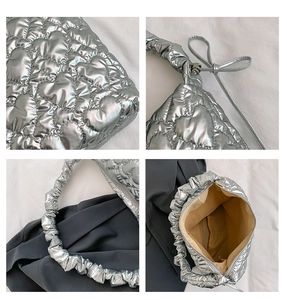 Detail of silver quilted heart pattern bag with ruffled handle and metallic zip closure