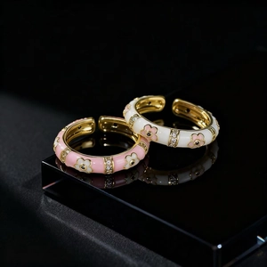 Elegant gold-tone open flower rings with pink enamel and sparkling zircon accents