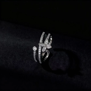Minimalist silver butterfly open ring with cubic zirconia inlay on black velvet background