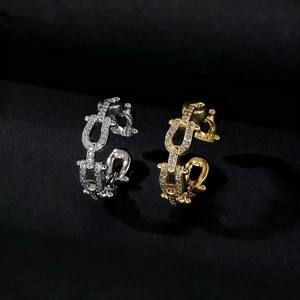 Sparkling pave zircon geometric chain link rings in gold and silver finish on black fabric